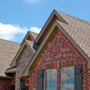 Brown-grey roof on red brick house